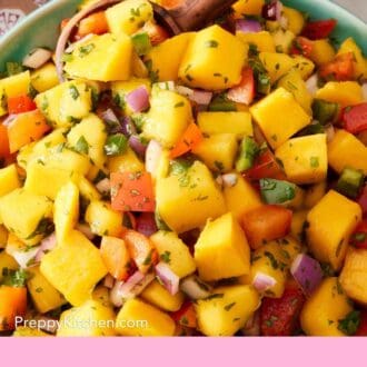 Pinterest graphic showing a closeup of mango salsa with peppers, onion, cilantro, and jalapeños.