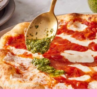Pinterest graphic showing a basil-garlic sauce spooned onto pizza.