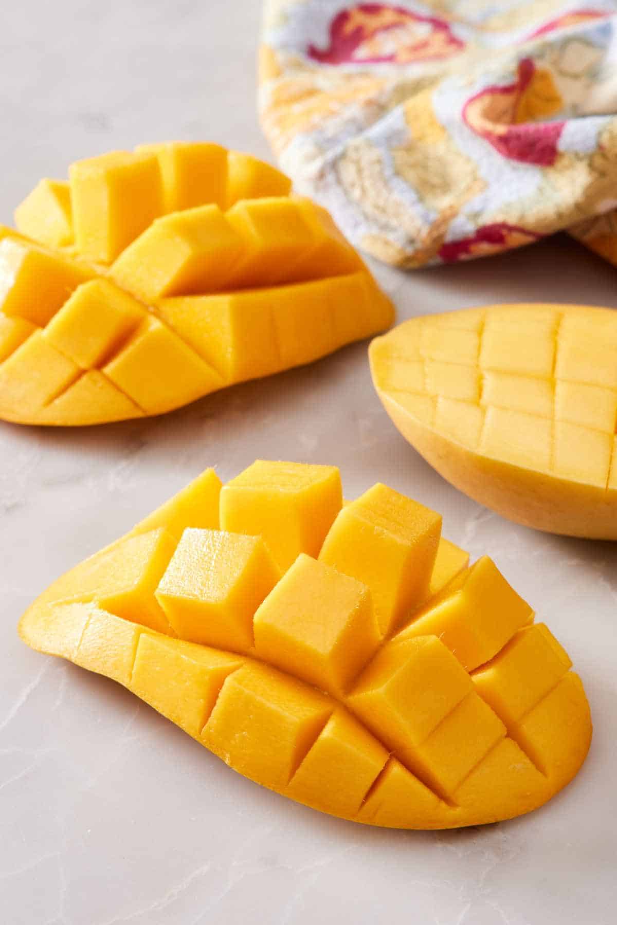 Mango halves scored with grids to create cubed mango.