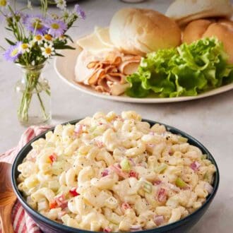 Pinterest graphic showing creamy summer salad in a bowl with sandwich ingredients in the background.