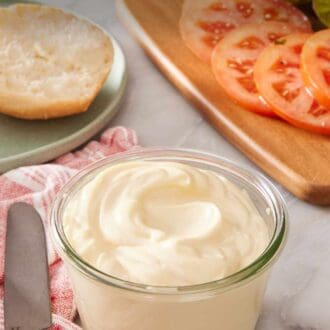 Pinterest graphic showing a small jar of homemade mayo with sandwich ingredients in the background.
