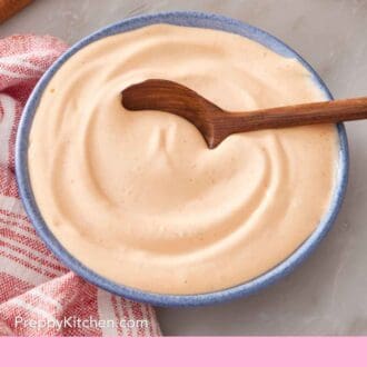 Pinterest graphic showing spicy mayo in a small blue bowl.