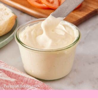 Pinterest graphic showing a butter knife dipped into a small jar of homemade mayo.