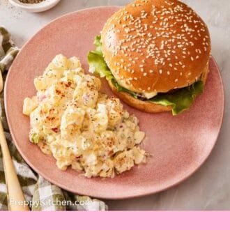 Pinterest graphic showing potato salad on a plate with a burger, with black pepper in a bowl in the background.