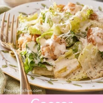 Pin image showing a Caesar salad with creamy dressing on a plate.