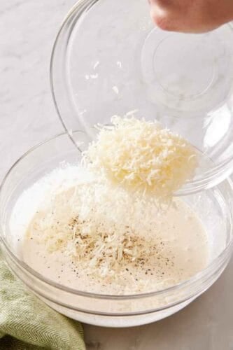 Parmesan cheese added to the whisked Caesar dressing mixture,