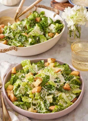A plate of Caesar Salad with the serving bowl in the background.