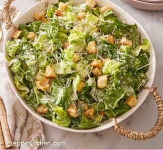 Pinterest graphic showing an overhead shot of Caesar salad in a large bowl.