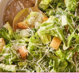 Pinterest graphic showing a close-up of Caesar salad with large serving utensils.