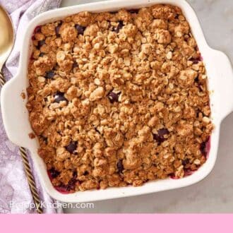Pinterest graphic showing a baking dish with cherry crisp.