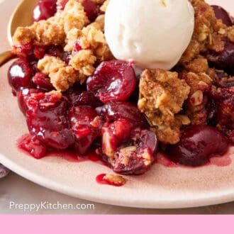 Pinterest graphic showing a close-up of cherry crisp with ice cream.