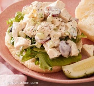 Pinterest graphic showing a chicken salad sandwich with the top bun on the side.