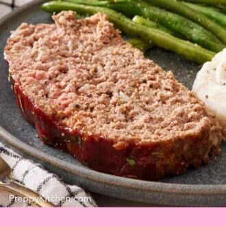 Pinterest graphic showing a close up of a slice of meatloaf on a plate with side dishes.