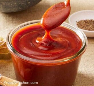Pinterest graphic showing a spoon dipped into a glass jar of BBQ sauce.