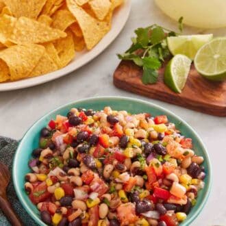 Pinterest graphic showing a bowl of homemade cowboy caviar with chips in the background.