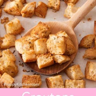 Pinterest graphic showing a close up of a wooden spoon scooping some croutons, with the rest of them still on the baking sheet.