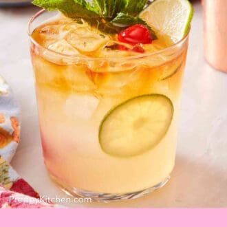 Pinterest graphic showing a close up of a mai tai drink with garnish.