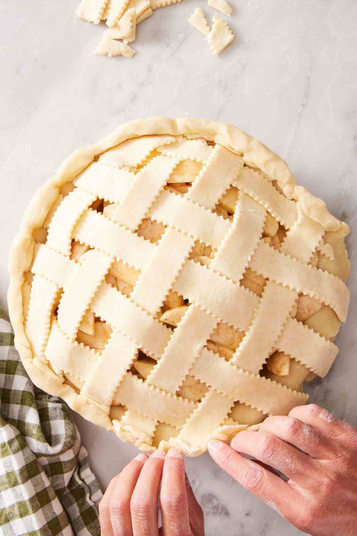 Overhead shot of a lattice top crust arranged on an apple pie.