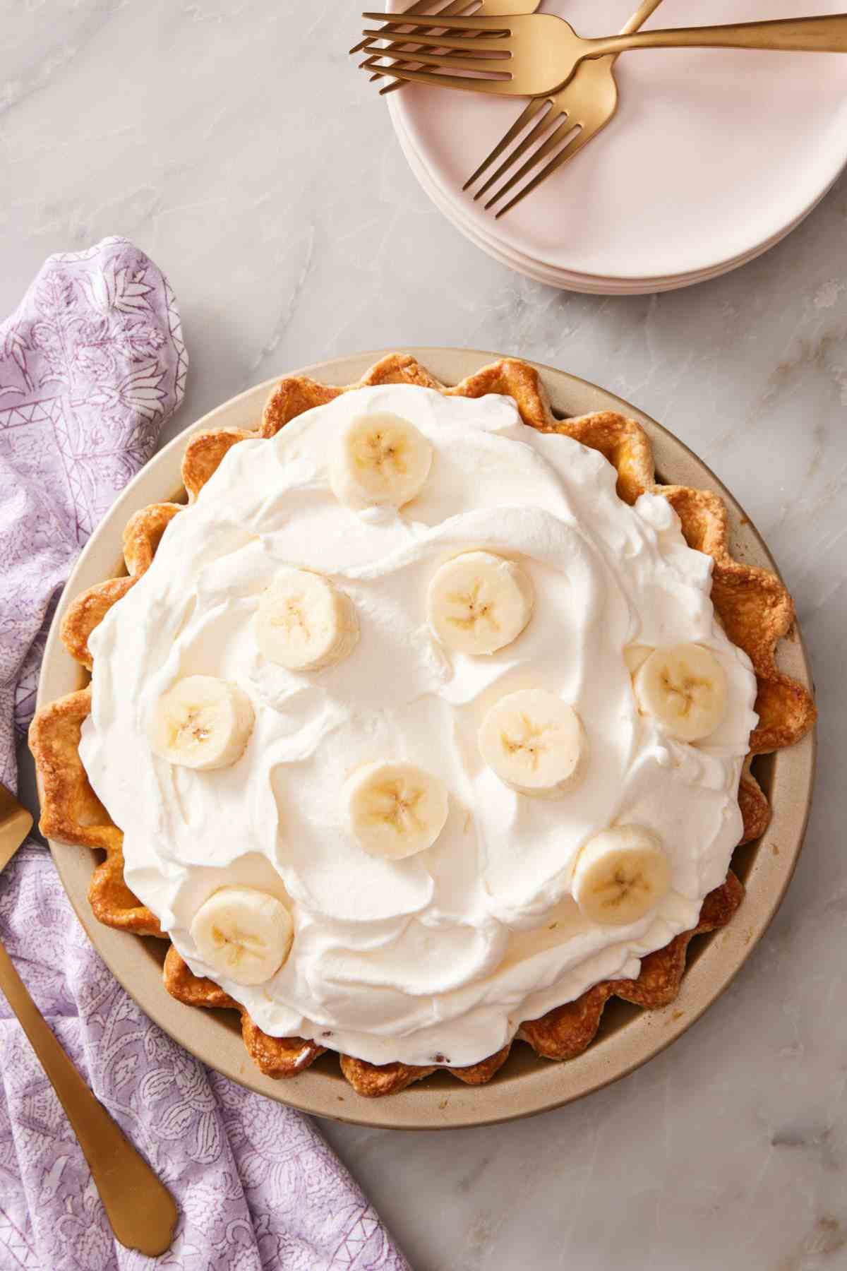 Overhead shot of classic banana cream pie decorated with sliced bananas.