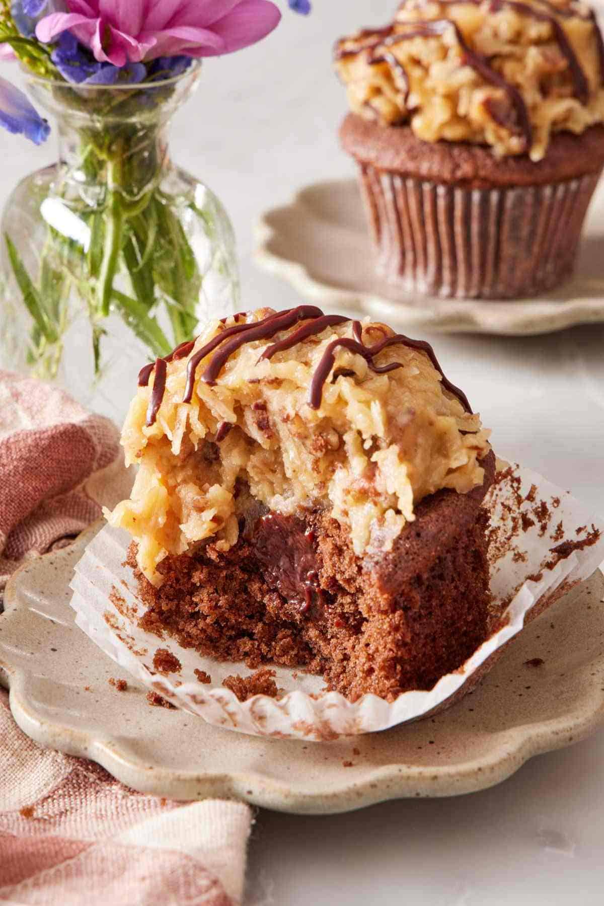 Close-up of a German chocolate cupcake with a bite out.