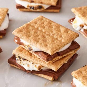 Close-up of s'mores, with two stacked, on a marble countertop.