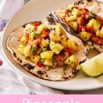 Pinterest graphic showing grilled tortillas topped with fresh pineapple salsa with a lime wedge on the side.