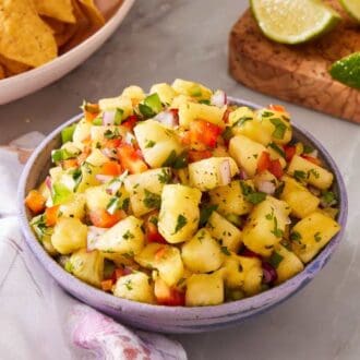 Pineapple salsa in a bowl on a marble countertop.