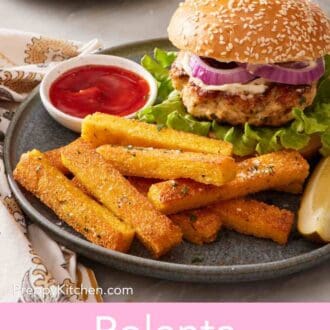 Pinterest graphic showing a burger and polenta fries on a plate with ketchup.