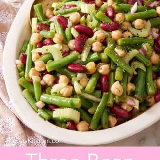 Pinterest graphic showing easy bean salad in a white platter with a serving spoon.