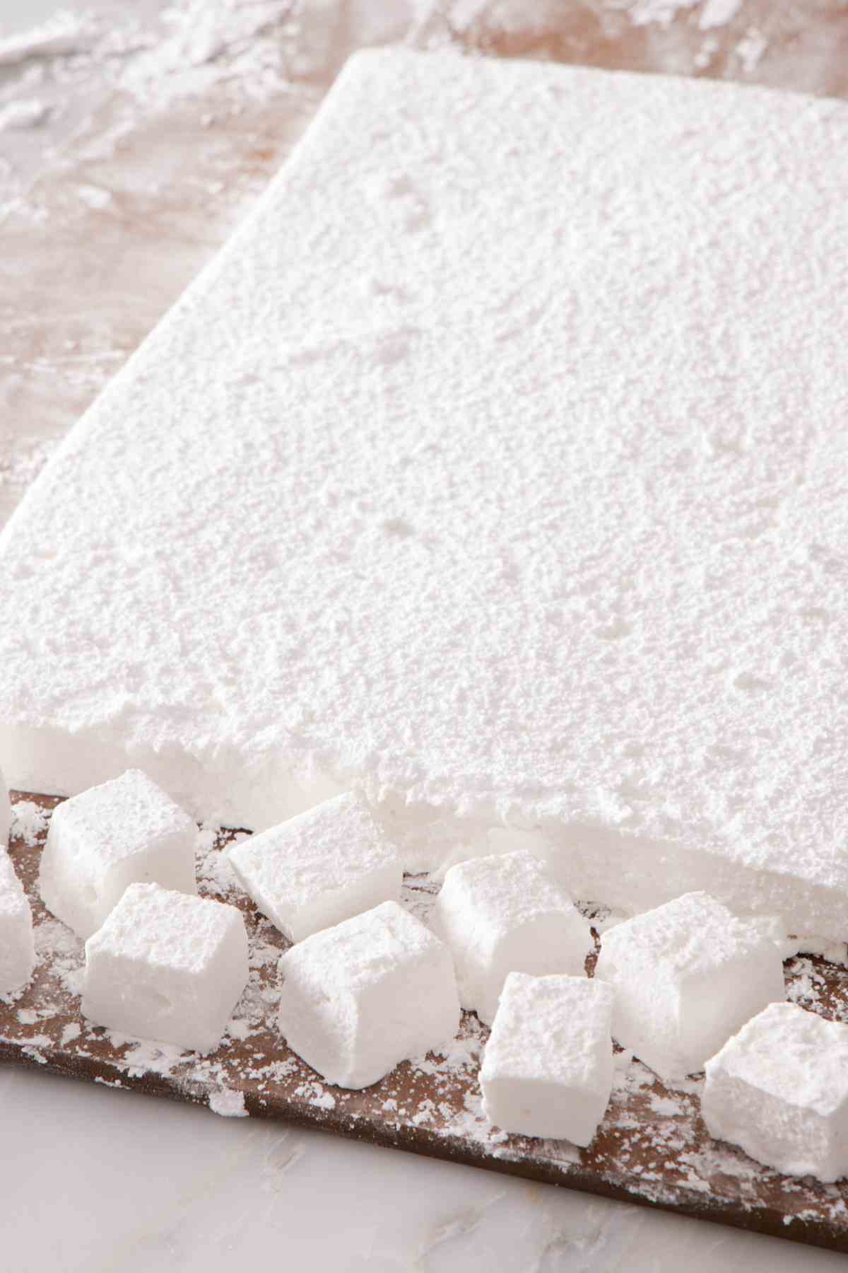 A thin slab of marshmallow with a few mini marshmallows cut out.