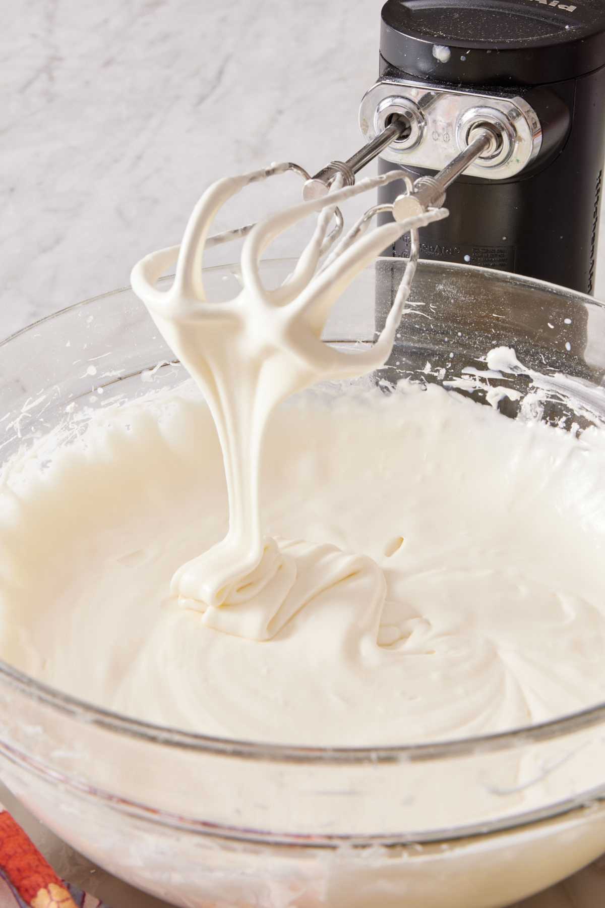 Too-runny consistency of cream cheese frosting made using tub cream cheese instead of block cream cheese.