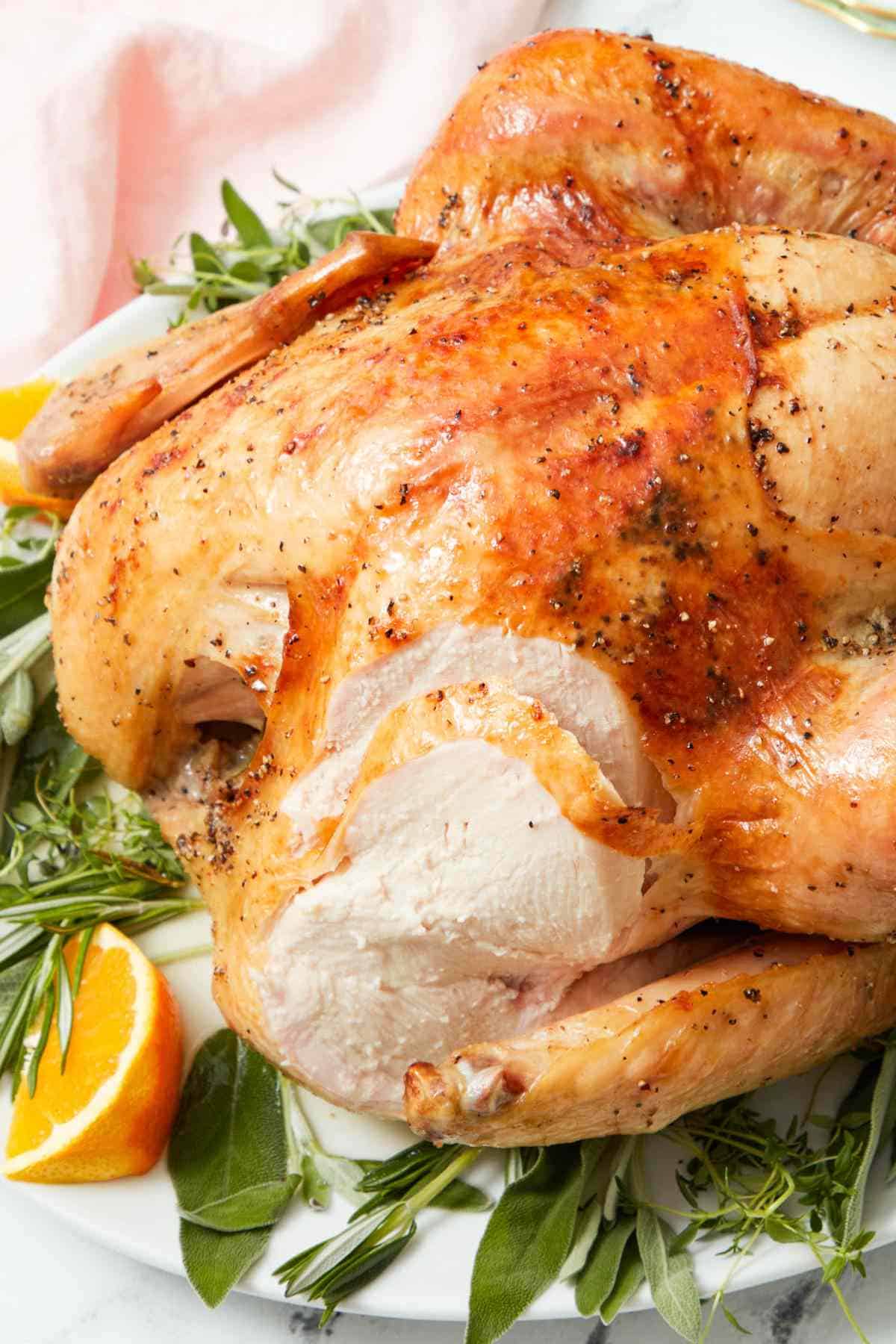 Roasted Thanksgiving turkey with a slice cut off.