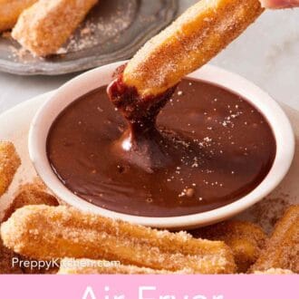 Pinterest graphic showing an air fryer churro dipped into sauce, with more churros around.
