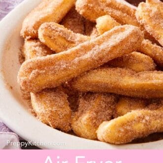 Pinterest graphic showing a close-up of a platter of air fryer churros.