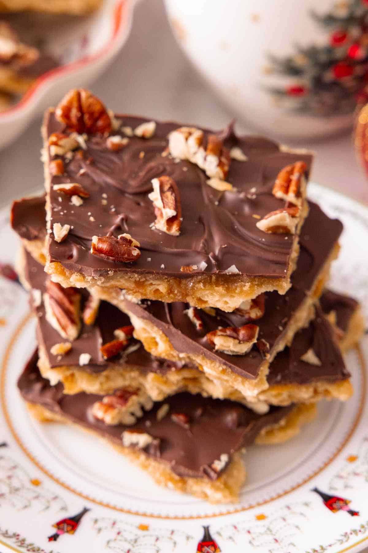 A stack of Christmas cracker candy on a festive plate.