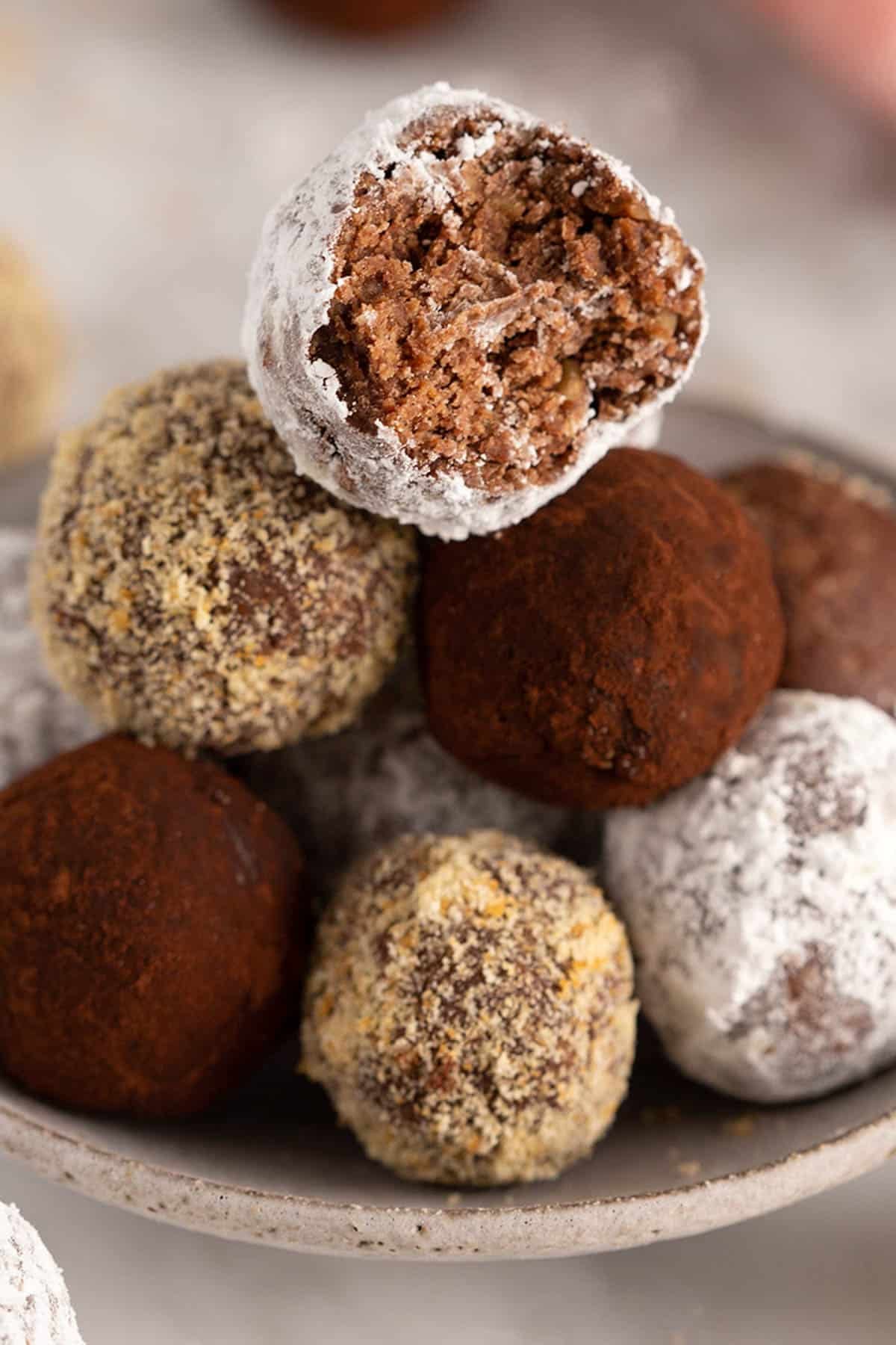 Close-up of a pile of rum balls, one with a bite taken out.