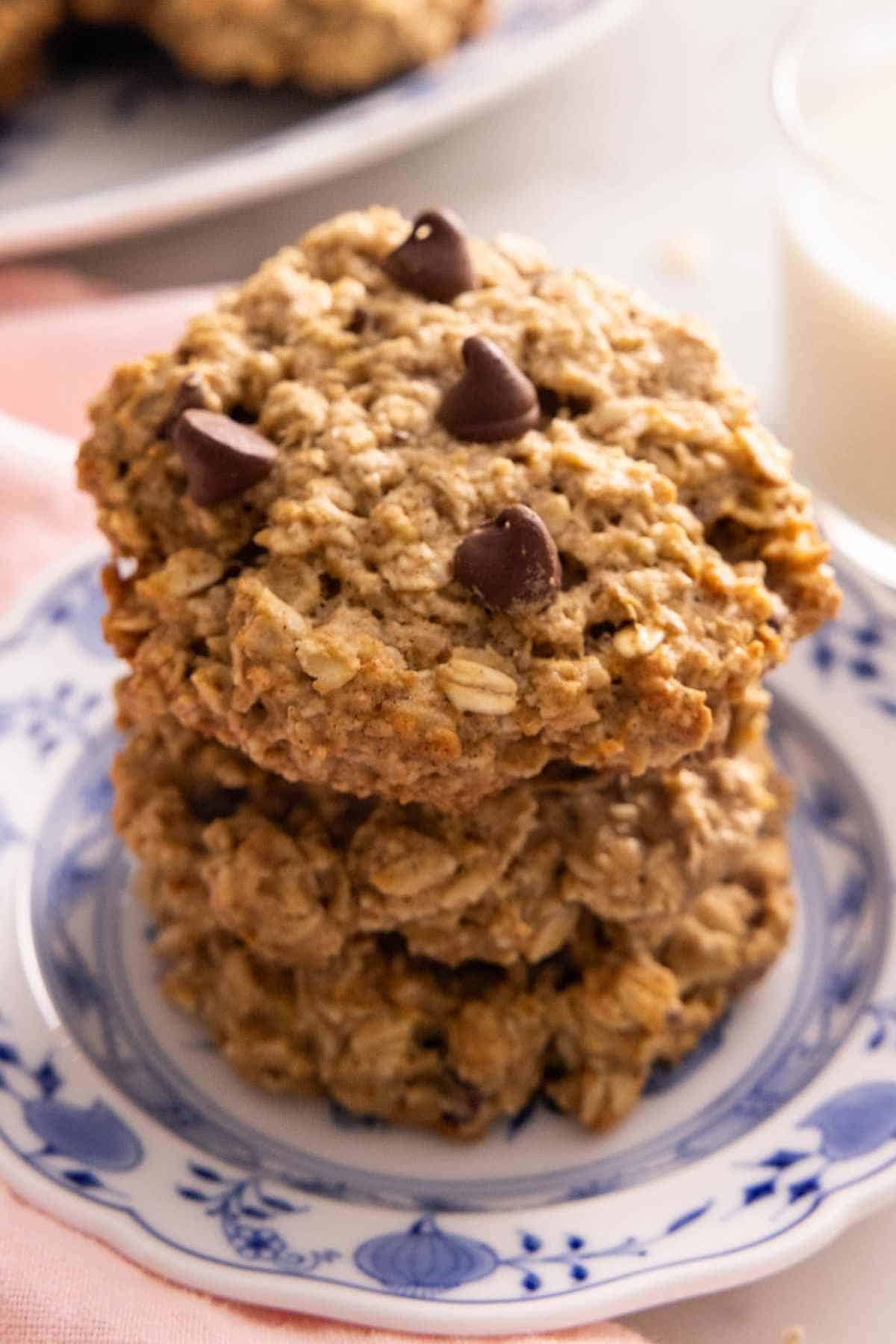 A stack of chocolate chip banana oatmeal cookies on a patterned plate.
