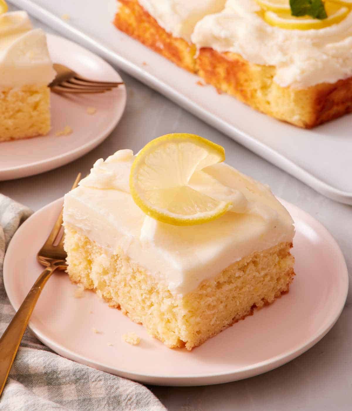 Close up of a slice of lemon sheet cake on a plate.