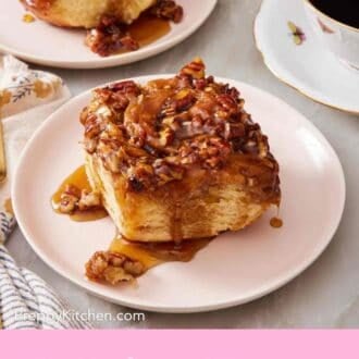 Pinterest graphic of a sticky bun on a plate with another in the background.