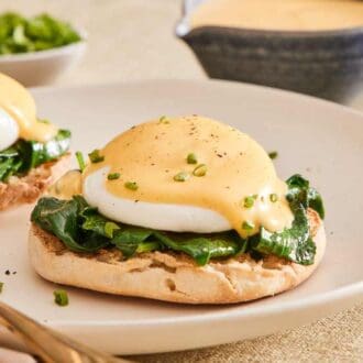 Eggs Florentine on a plate with a fork.