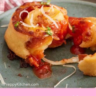 Pinterest graphic showing a close-up of a homemade pizza roll on a plate, torn in half.