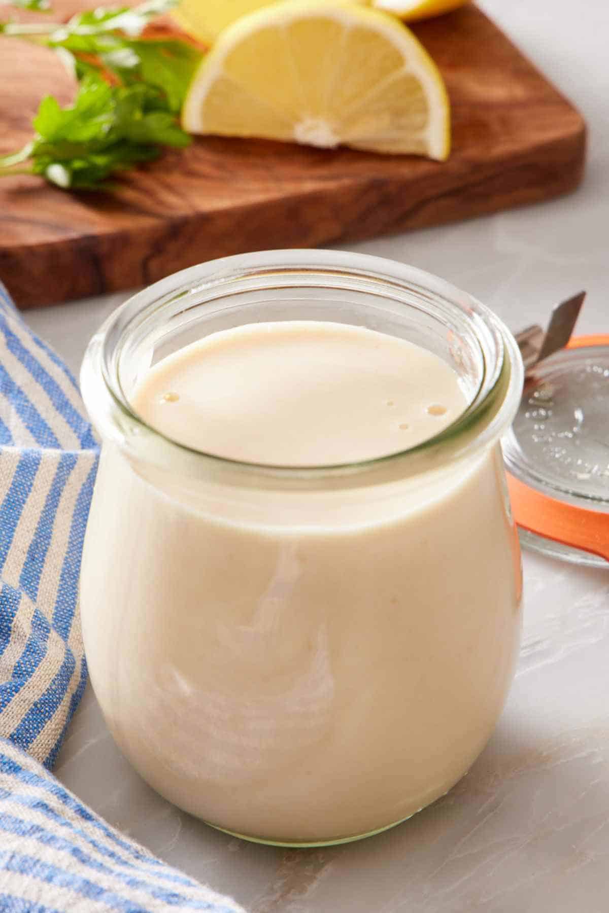 A glass jar of homemade tahini sauce.