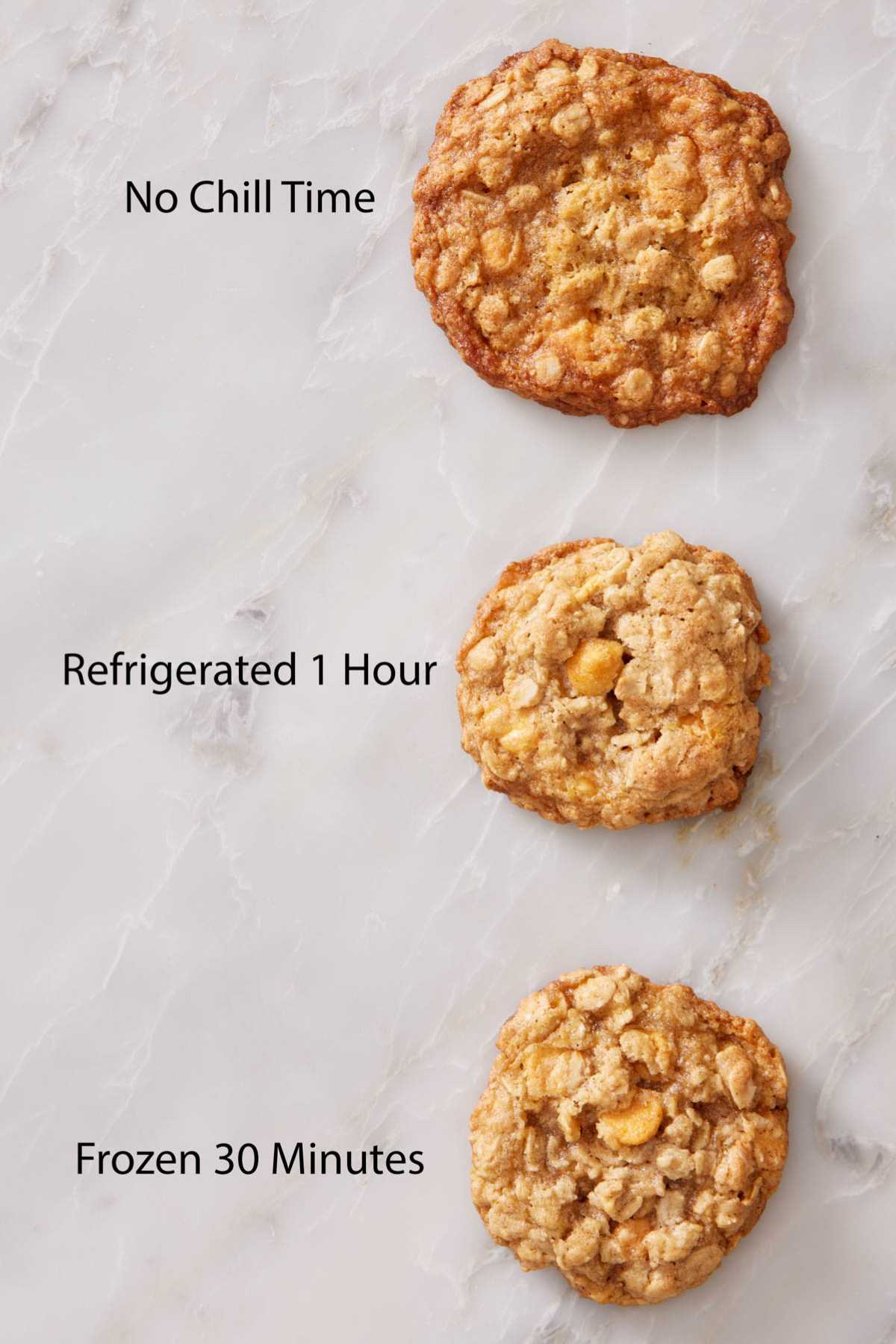 Three baked oatmeal scotchies on a counter showing the difference after the dough was not chilled, refrigerated for 1 hour, and frozen for 30 minutes.