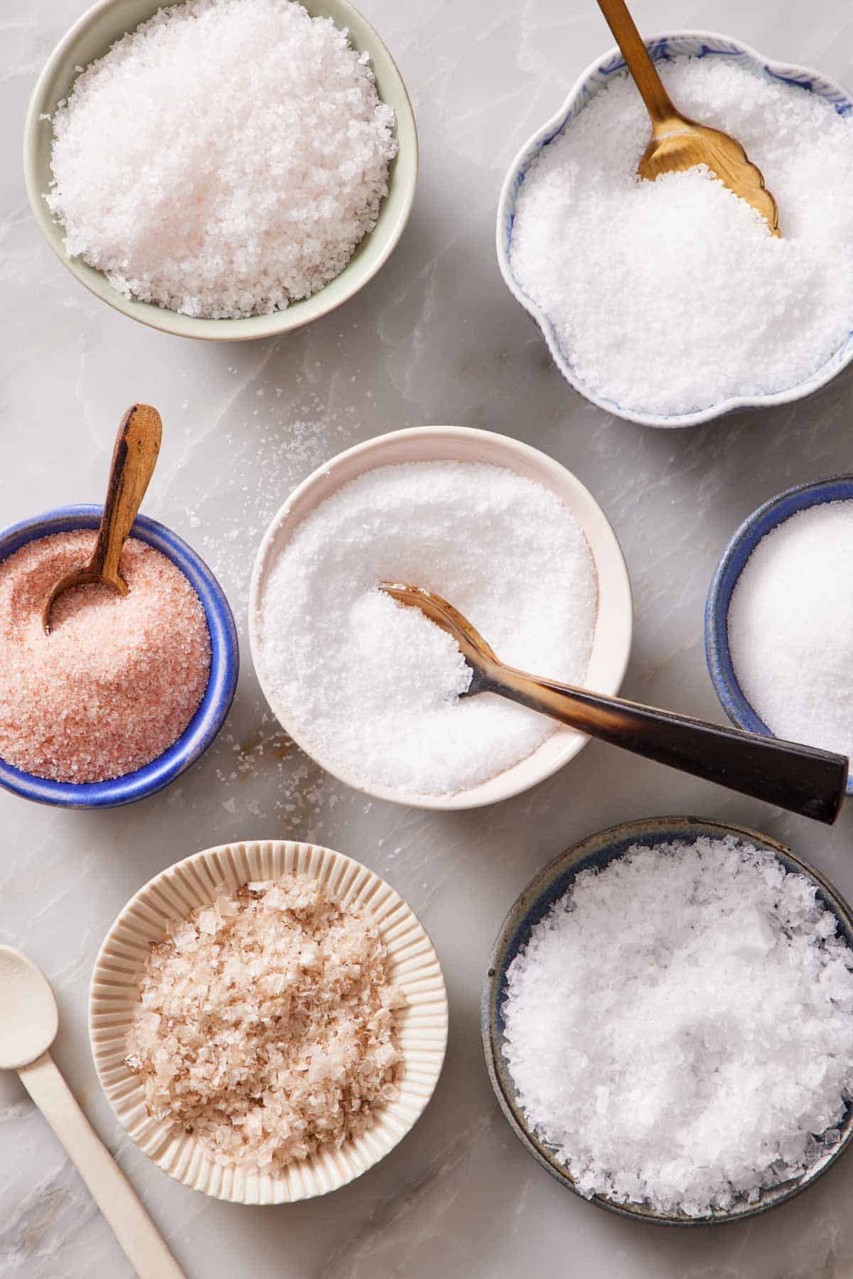 Overhead shot of bowls of different types of salt.